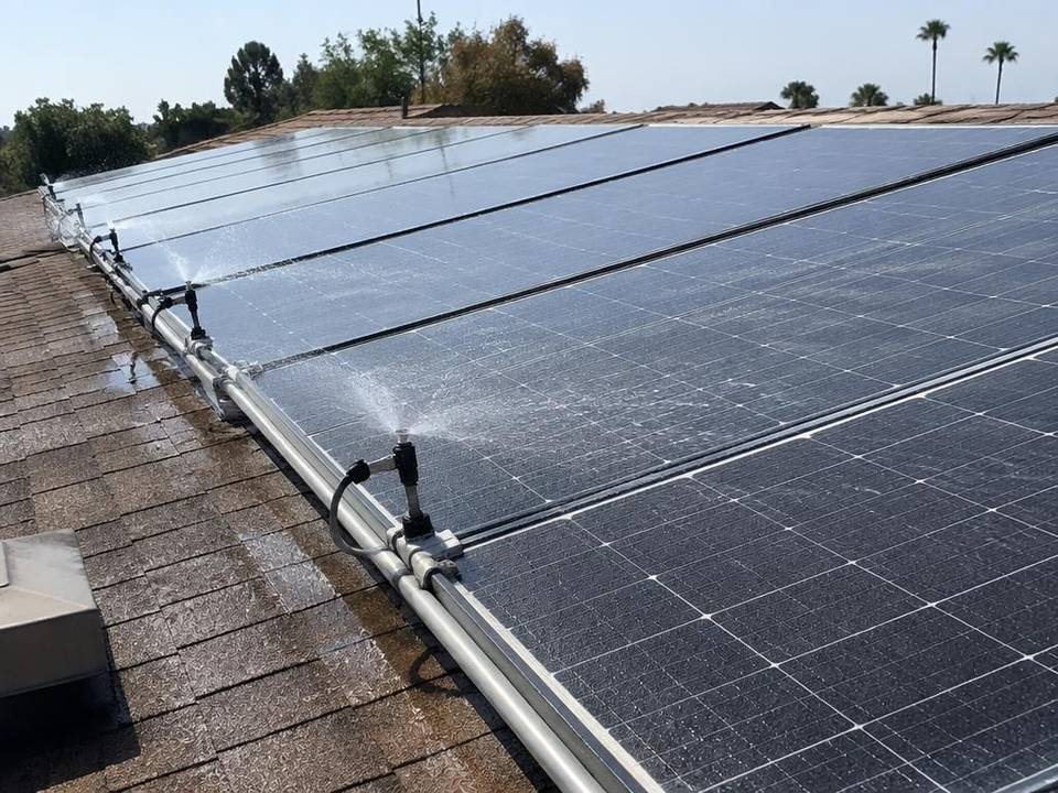 Solar panel rinse nozzles on a rooftop array