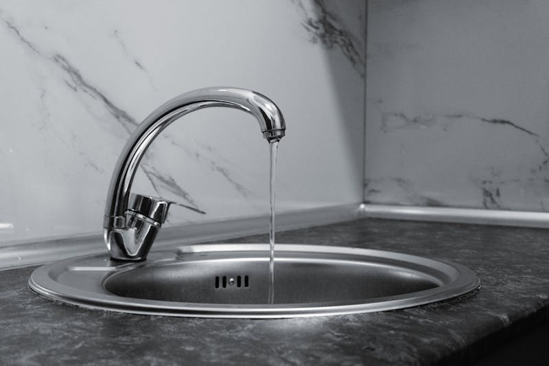 Modern chrome kitchen faucet with clean running water